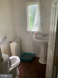 4713 Alhambra Avenue Baltimore, MD 21212 - Photo 3 of 8 a bathroom with a sink toilet and window