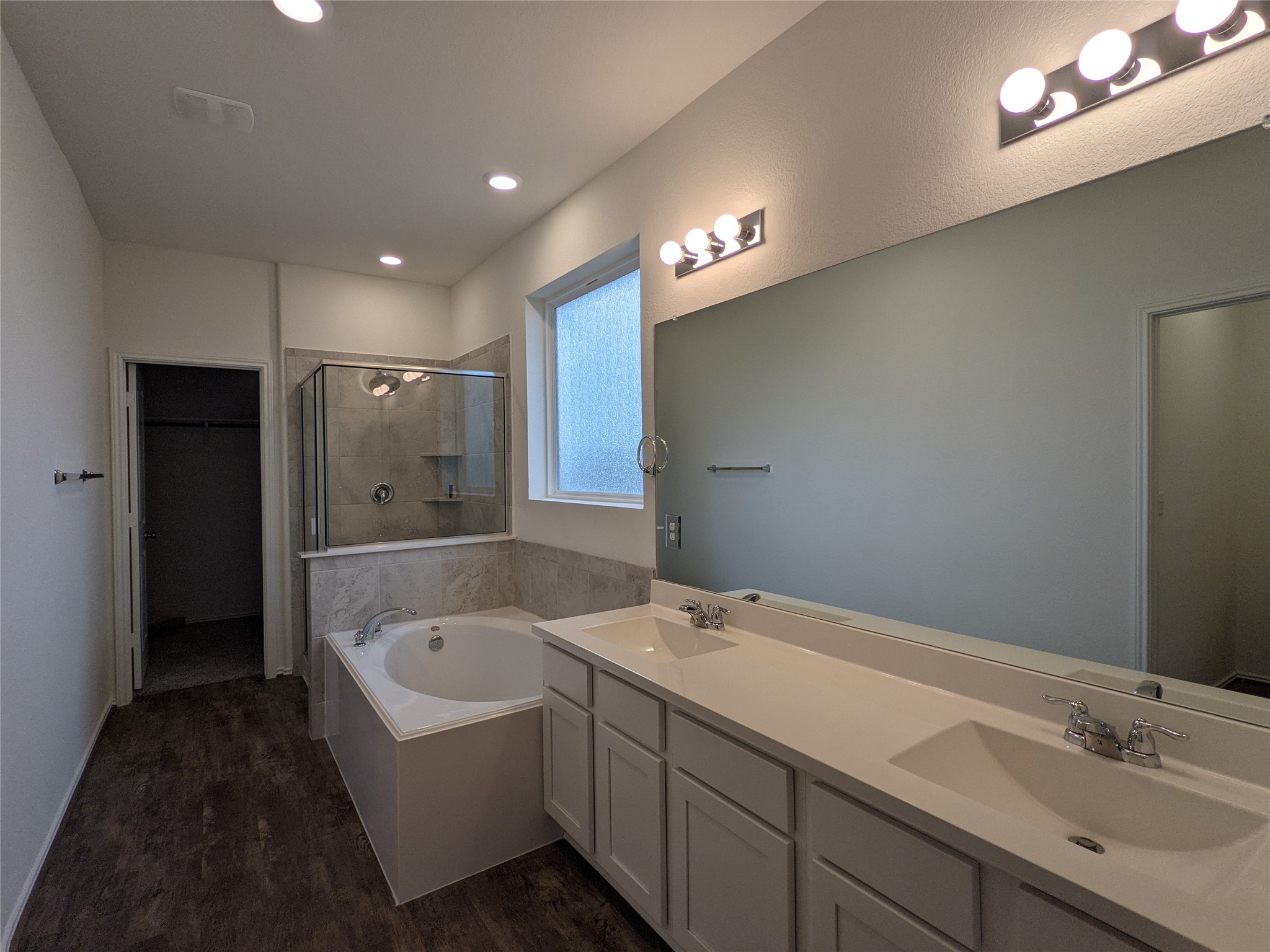 100 Montauk Loop Georgetown, TX 78628 - Photo 13 of 21 Indulge in a primary bathroom offering a soaking tub, dual vanity, and separate shower for a spa-like retreat.