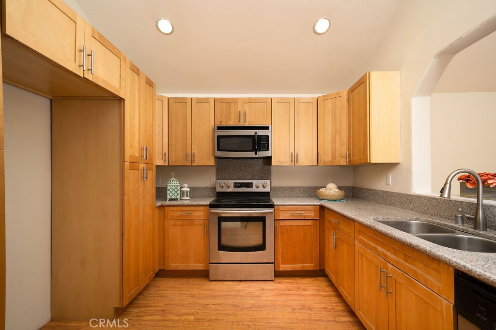 8851 Sonora Road Phelan, CA 92371 - Photo 6 of 26 a kitchen with a sink a stove and cabinets