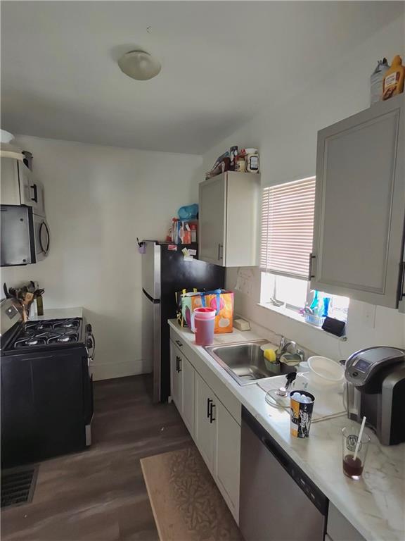 1131 13th Street McKees Rocks, PA 15136 - Photo 4 of 13 a kitchen that has a lot of cabinets and wooden floor