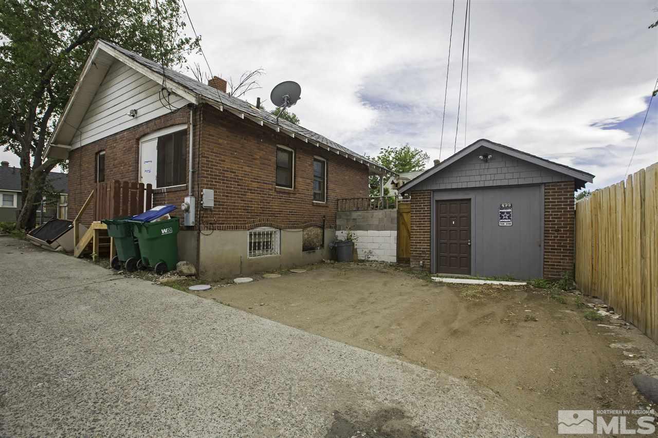 425 Roberts Street, Unit ROBERTS & 423 Reno, NV 89502 - Photo 12 of 25 a view of a house with a small yard and wooden fence