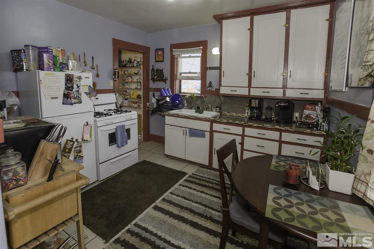 425 Roberts Street, Unit ROBERTS & 423 Reno, NV 89502 - Photo 17 of 25 a kitchen with stainless steel appliances granite countertop a stove a sink and a refrigerator
