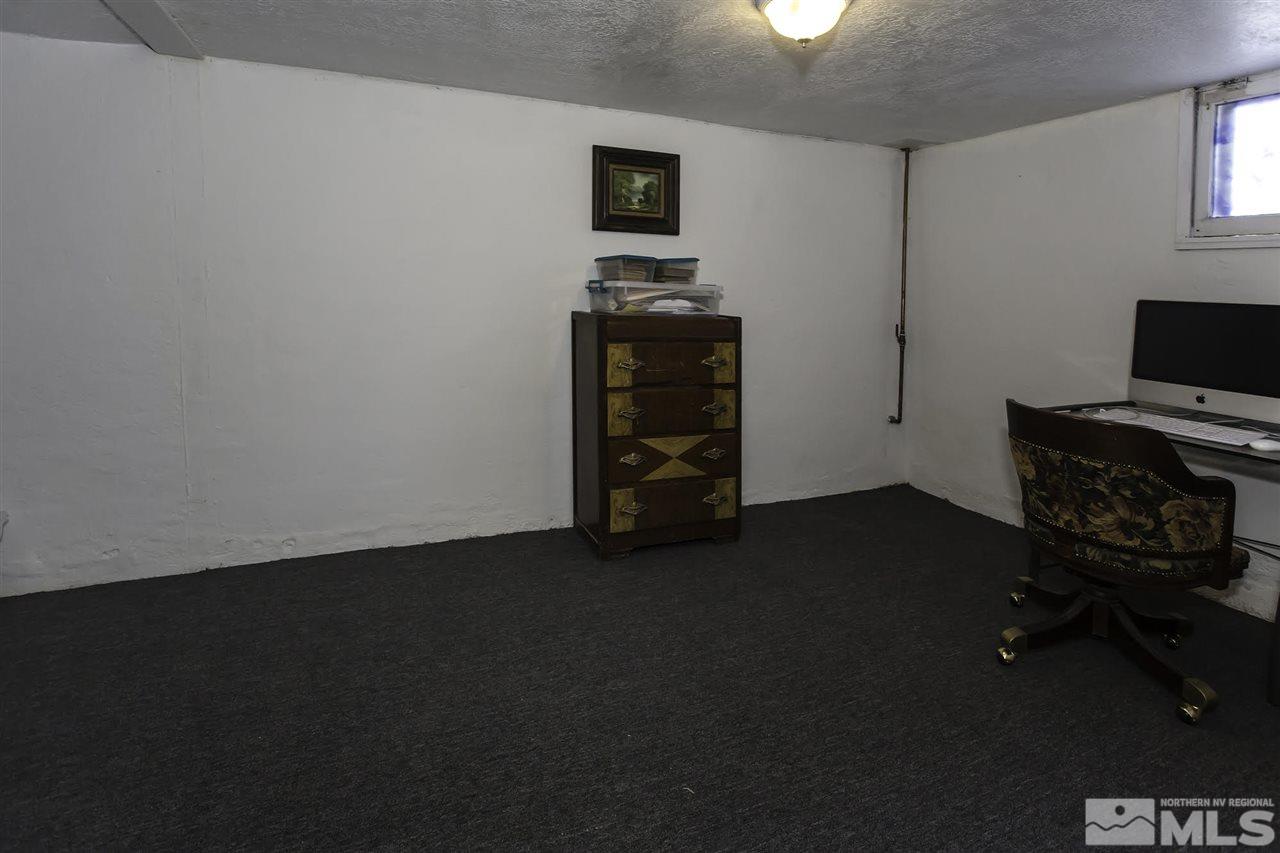 425 Roberts Street, Unit ROBERTS & 423 Reno, NV 89502 - Photo 22 of 25 an empty room with a fireplace and wooden floor