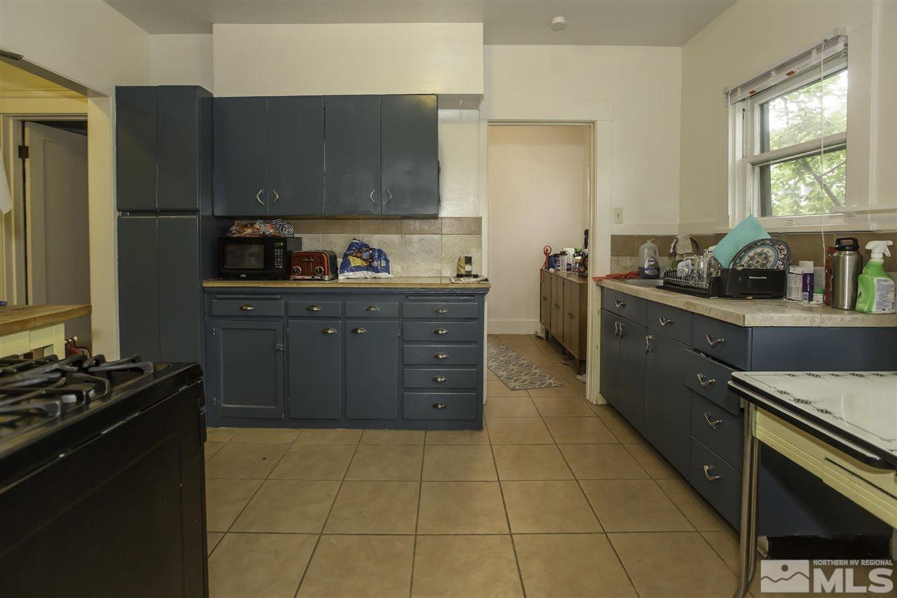 425 Roberts Street, Unit ROBERTS & 423 Reno, NV 89502 - Photo 4 of 25 a kitchen with stainless steel appliances granite countertop a stove a sink and a refrigerator