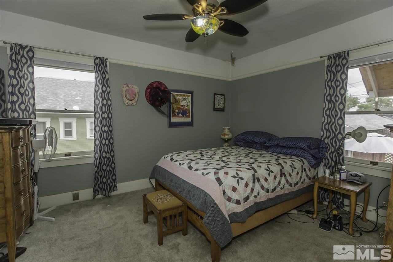 425 Roberts Street, Unit ROBERTS & 423 Reno, NV 89502 - Photo 6 of 25 a bedroom with a bed and a chandelier