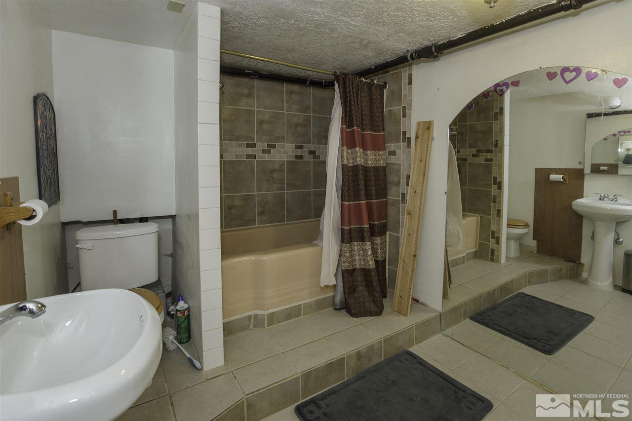 425 Roberts Street, Unit ROBERTS & 423 Reno, NV 89502 - Photo 7 of 25 a bathroom with a tub and a shower