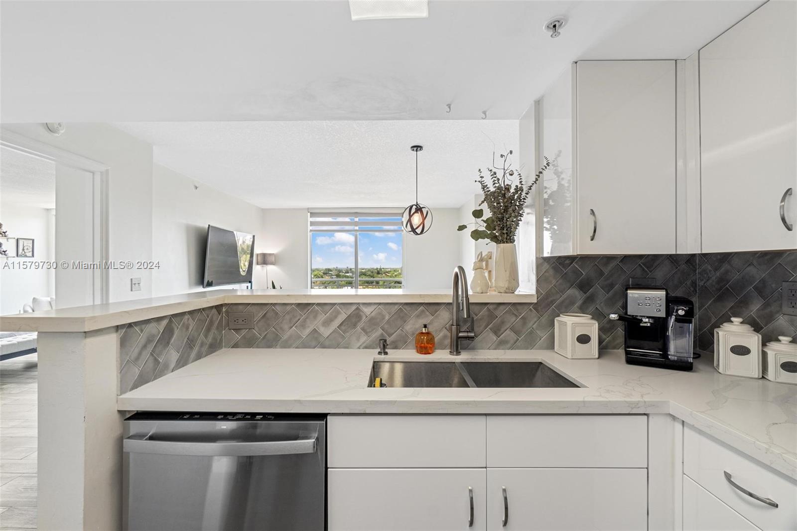 3000 Coral Way, Unit 703 Miami, FL 33145 - Photo 13 of 26 a kitchen with a sink and cabinets