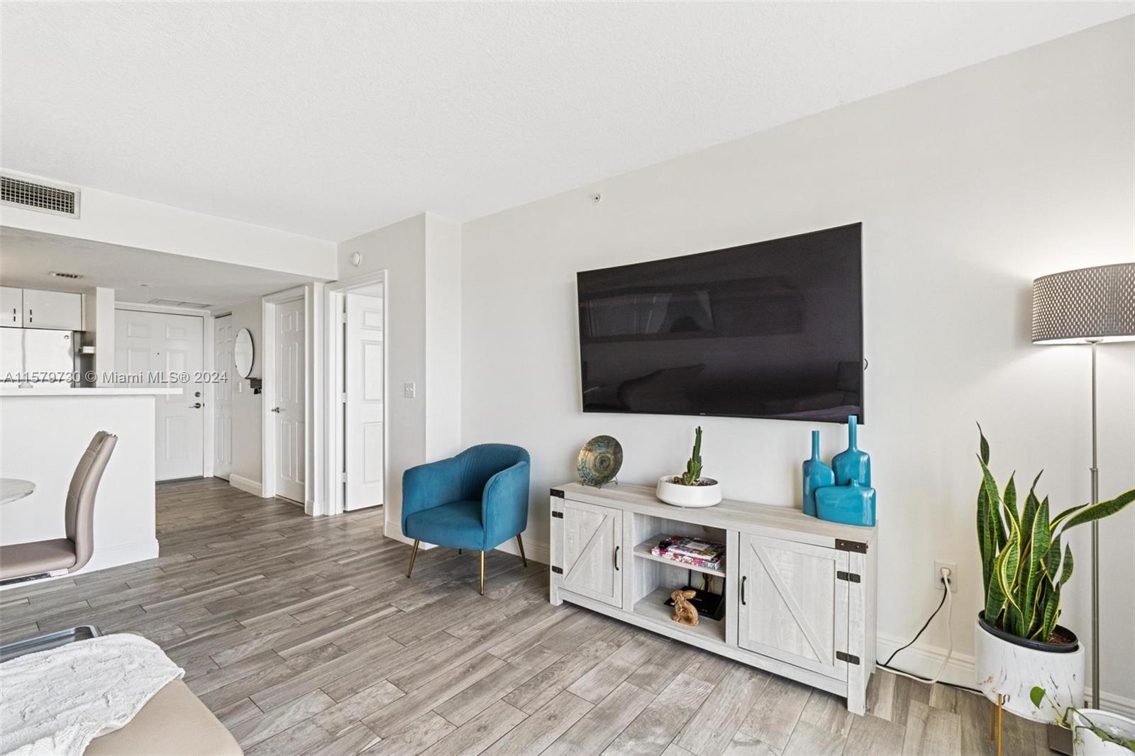 3000 Coral Way, Unit 703 Miami, FL 33145 - Photo 16 of 26 a living room with furniture and a flat screen tv