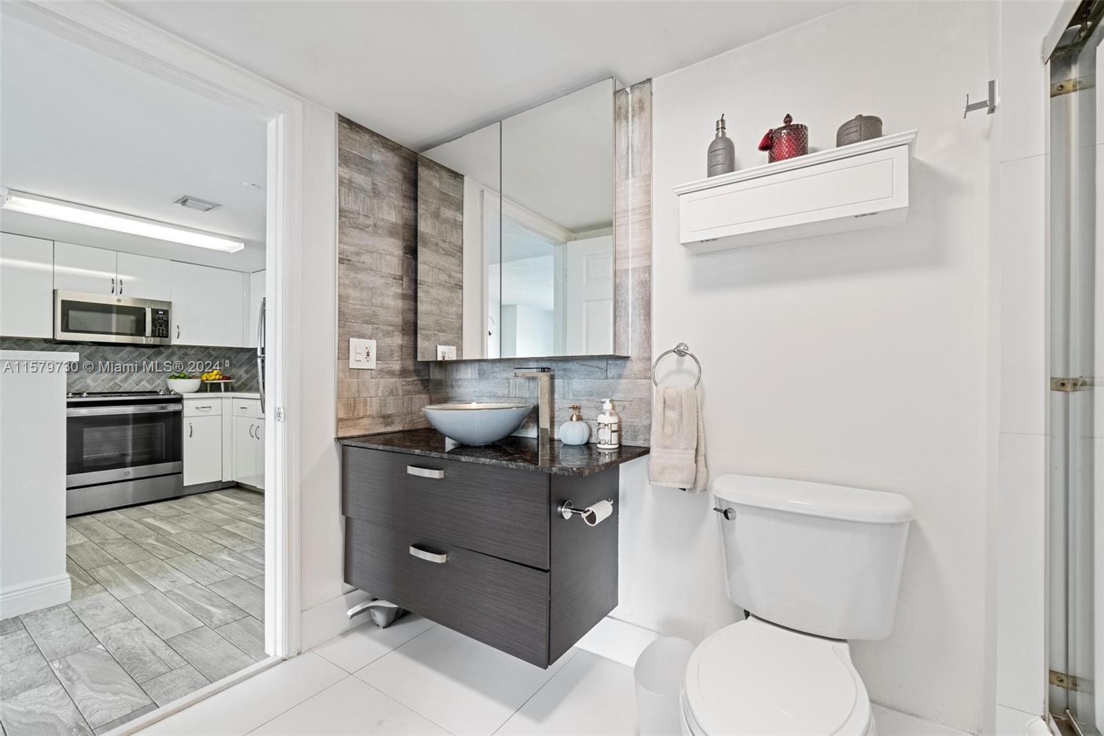 3000 Coral Way, Unit 703 Miami, FL 33145 - Photo 20 of 26 a bathroom with a toilet sink and mirror
