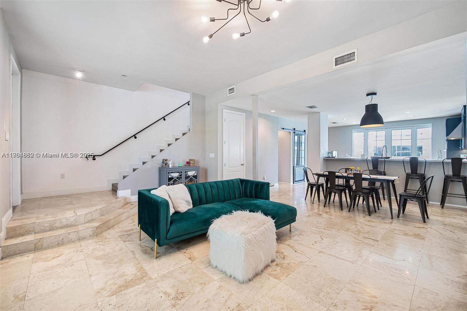 7765 Southwest 54th Court, Unit 7765 Miami, FL 33143 - Photo 11 of 30 a living room with furniture and a dining table