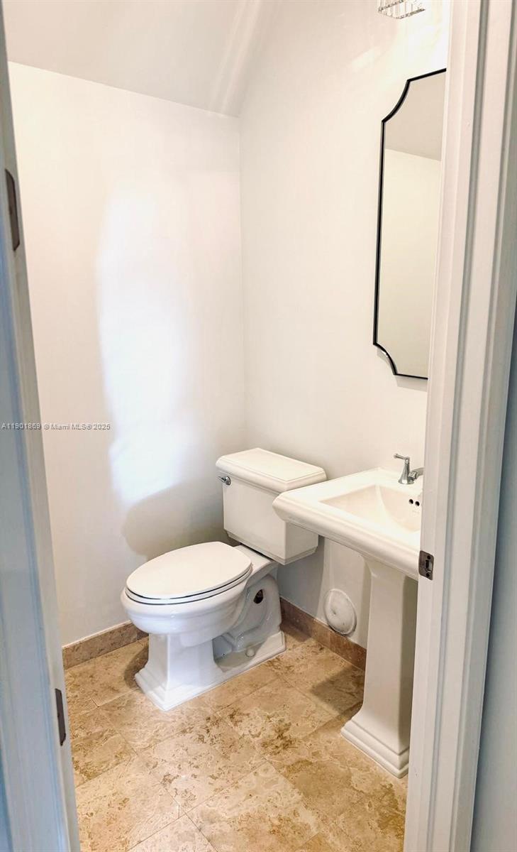 7765 Southwest 54th Court, Unit 7765 Miami, FL 33143 - Photo 12 of 30 a white toilet sitting next to a white sink
