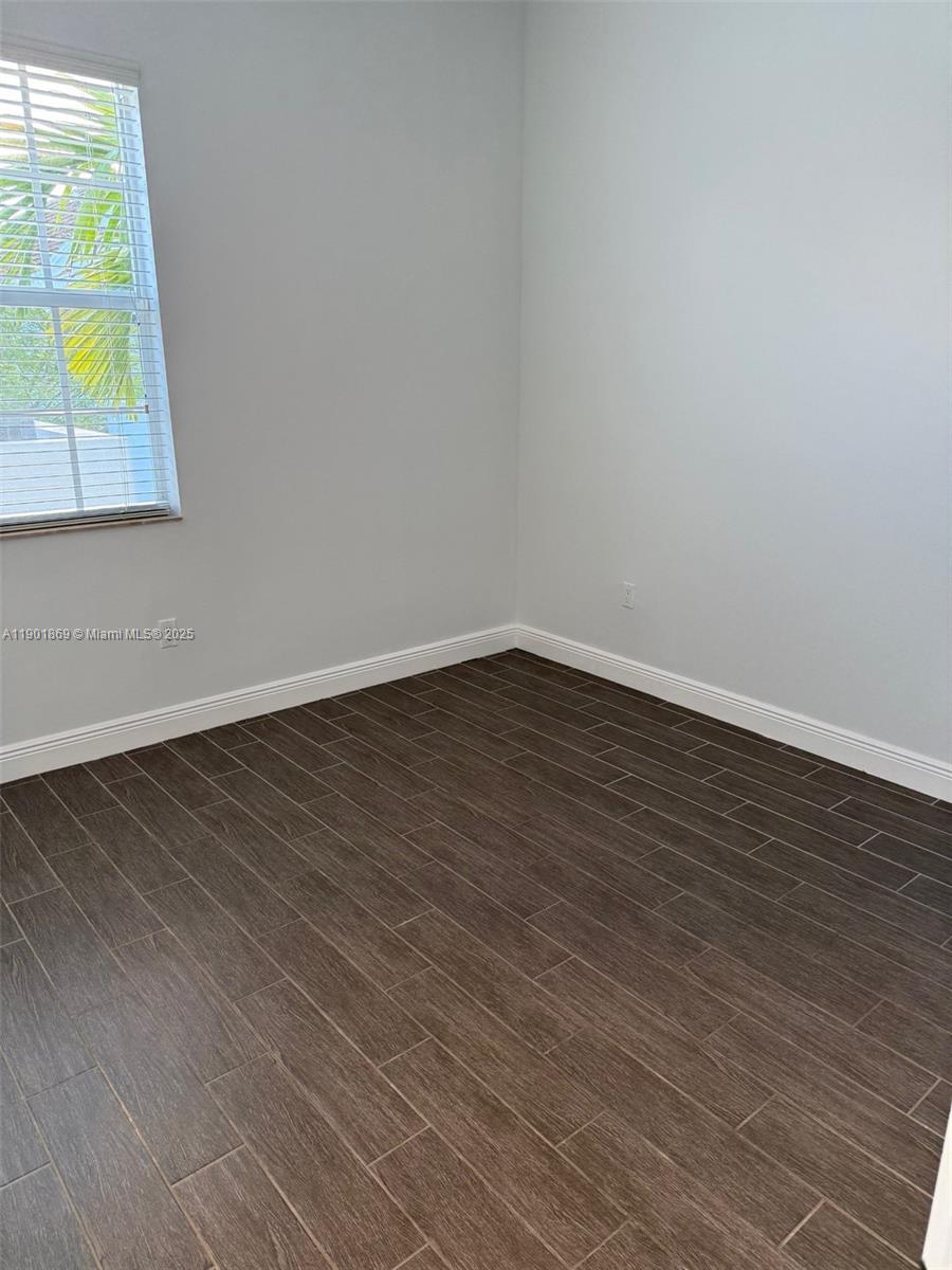 7765 Southwest 54th Court, Unit 7765 Miami, FL 33143 - Photo 17 of 30 a view of an empty room and window