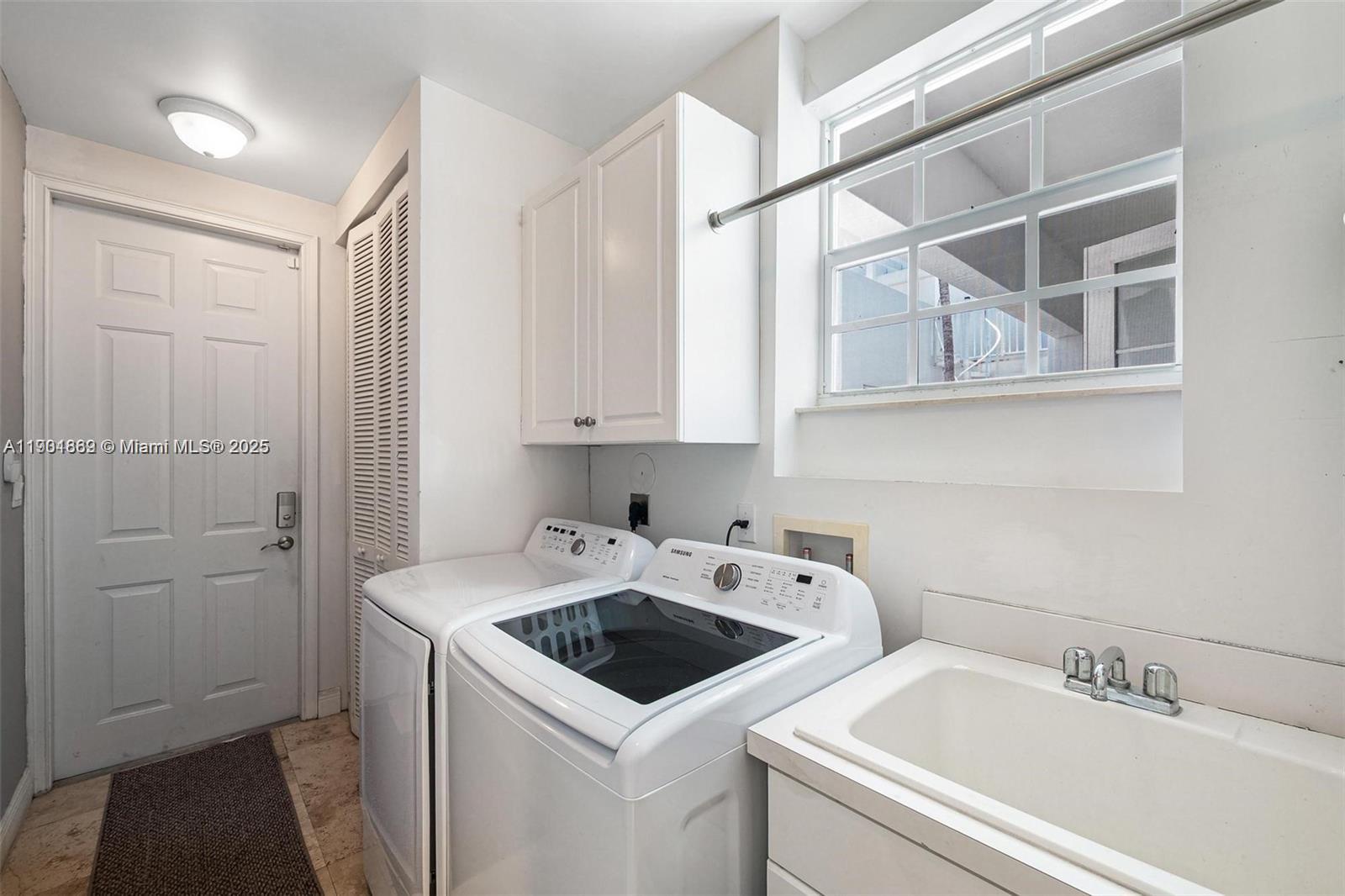 7765 Southwest 54th Court, Unit 7765 Miami, FL 33143 - Photo 22 of 30 a view of a utility room with sink dryer and washer