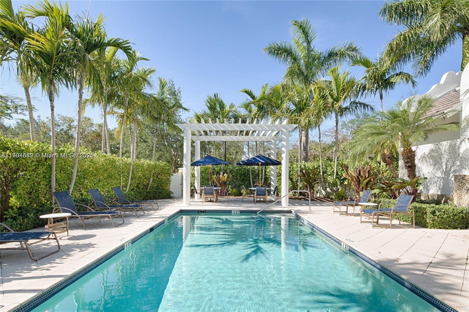 7765 Southwest 54th Court, Unit 7765 Miami, FL 33143 - Photo 24 of 30 a swimming pool with outdoor seating and yard
