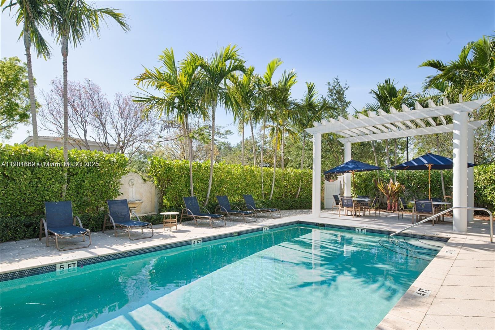 7765 Southwest 54th Court, Unit 7765 Miami, FL 33143 - Photo 25 of 30 a view of a backyard with a garden and swimming pool