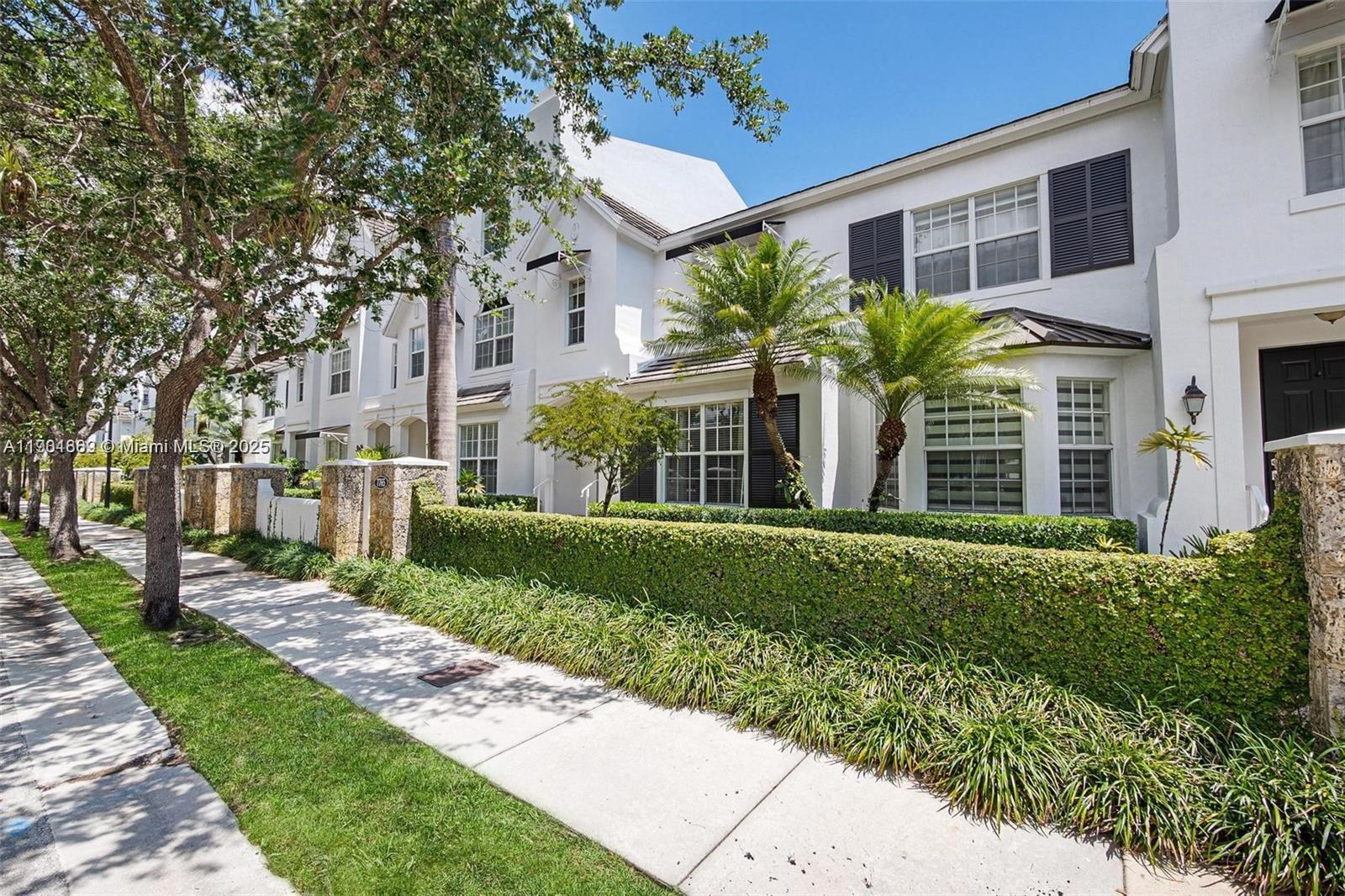 7765 Southwest 54th Court, Unit 7765 Miami, FL 33143 - Photo 3 of 30 a view of a brick house with a yard and potted plants