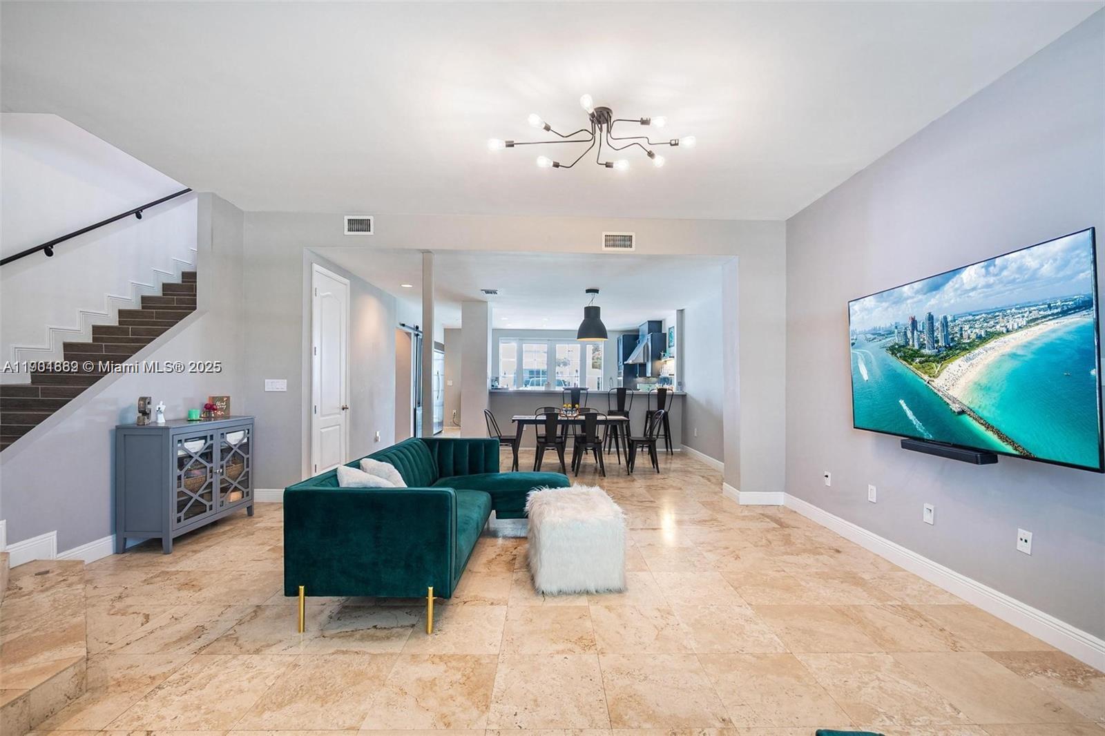7765 Southwest 54th Court, Unit 7765 Miami, FL 33143 - Photo 8 of 30 a living room with furniture and a chandelier