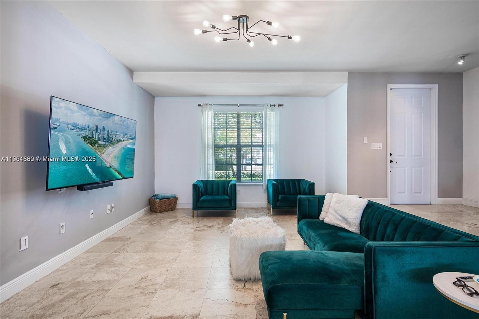 7765 Southwest 54th Court, Unit 7765 Miami, FL 33143 - Photo 9 of 30 a living room with furniture and a flat screen tv