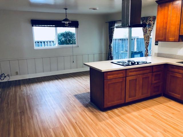 a kitchen with a wooden floor and a sink