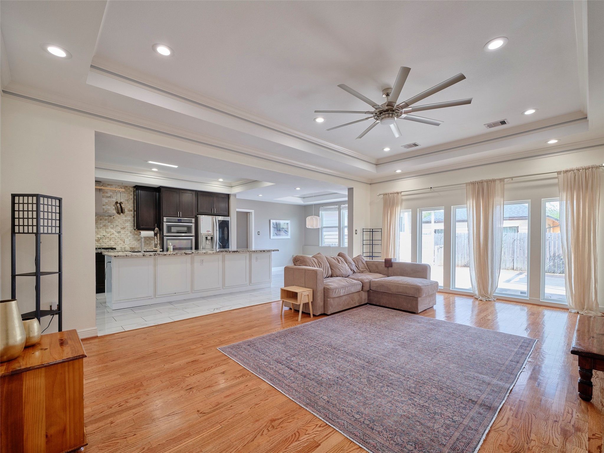 4219 Redbud Street Houston, TX 77051 - Photo 6 of 25 Experience seamless living in this inviting family room, effortlessly connected to a modern kitchen and a sunlit backyard.