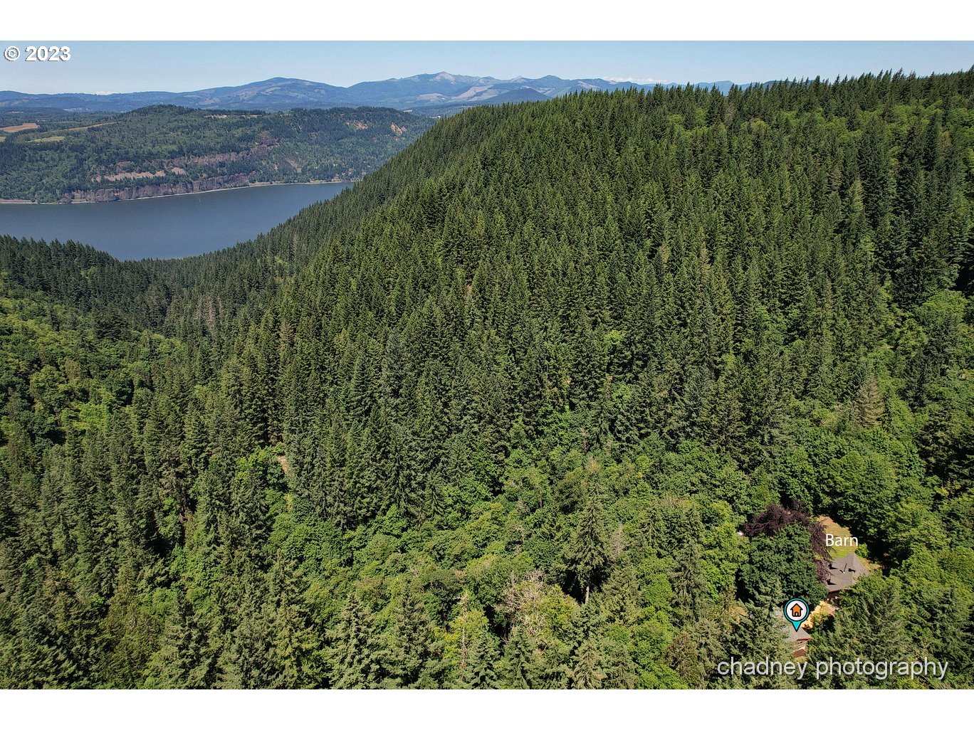 2847 Northeast Brower Road Corbett, OR 97019 - Photo 42 of 48 a view of a lush green hillside and a houses
