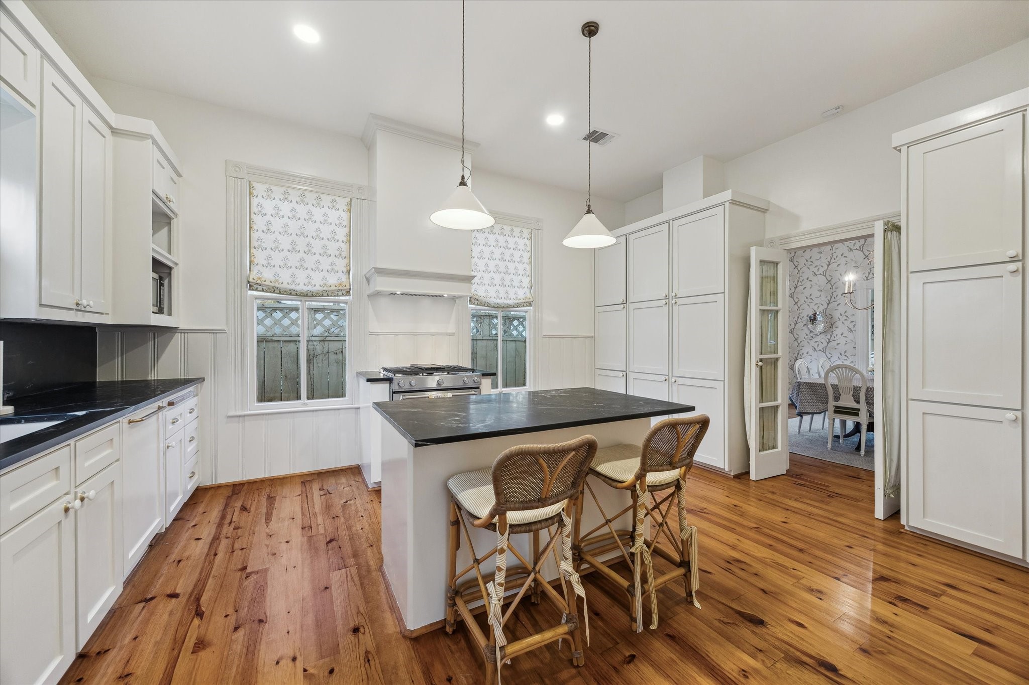 307 Archer Street Houston, TX 77009 - Photo 11 of 26 a kitchen with stainless steel appliances a dining table chairs stove and sink