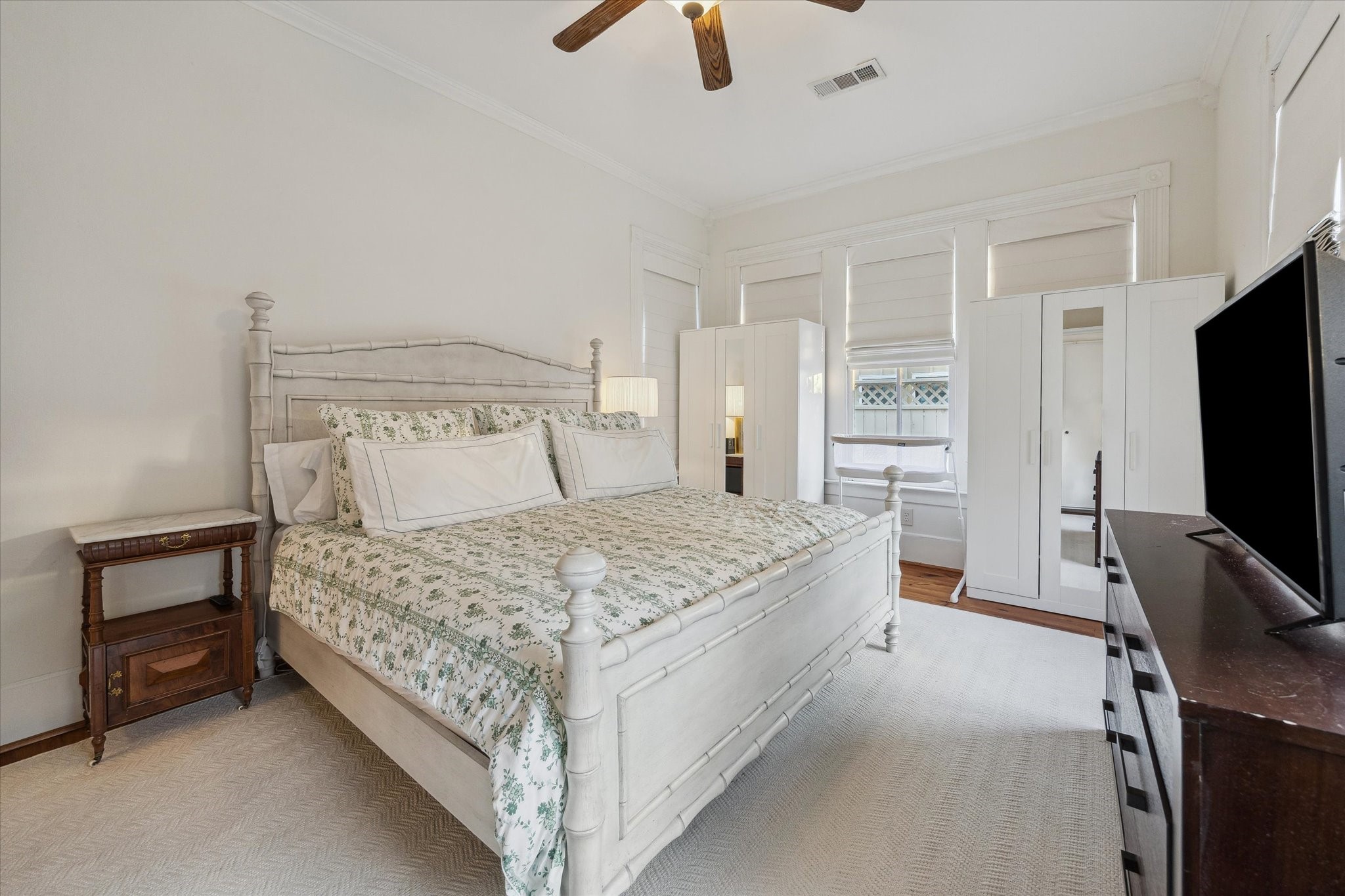307 Archer Street Houston, TX 77009 - Photo 14 of 26 a bedroom with a bed and a flat tv screen on the dresser