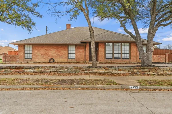 front view of a house with two trees