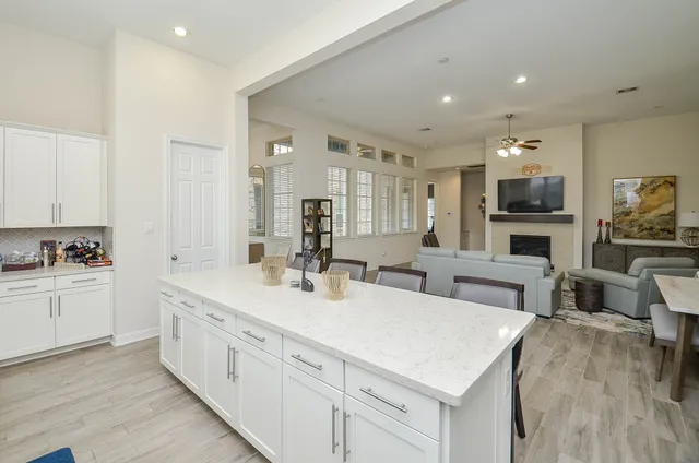 a large white kitchen with cabinets