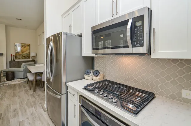 a stove top oven sitting inside of a kitchen