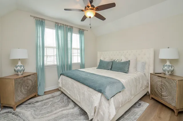 a bedroom with a bed and dresser with mirror