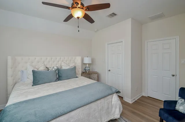 a bedroom with a bed and wooden floor
