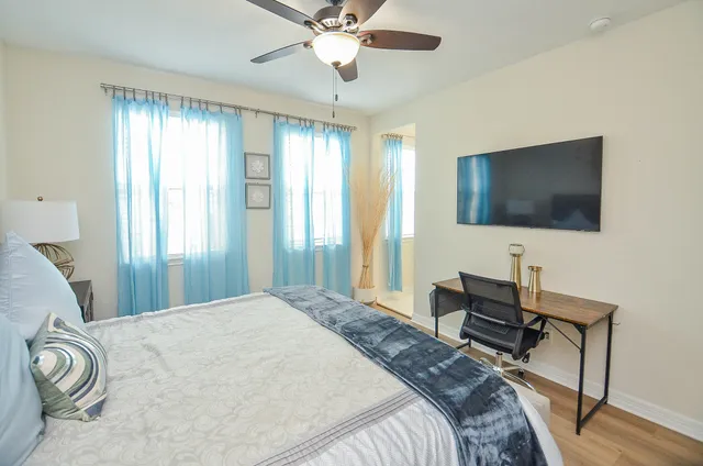 a bedroom with a bed and a flat screen tv