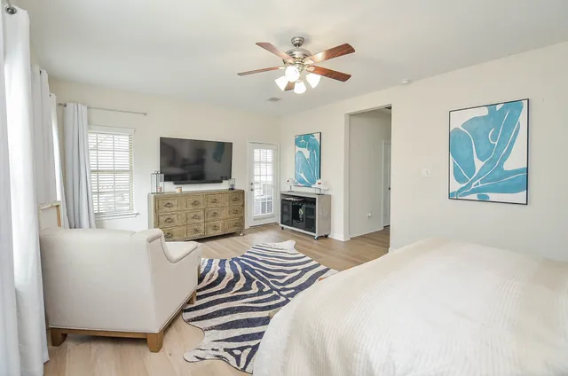 a bedroom with a bed and a flat screen tv