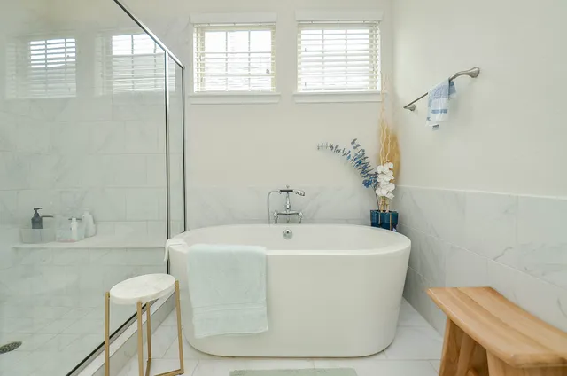 a white bath tub sitting next to a white sink