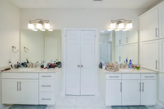 a bathroom with a sink vanity and a mirror