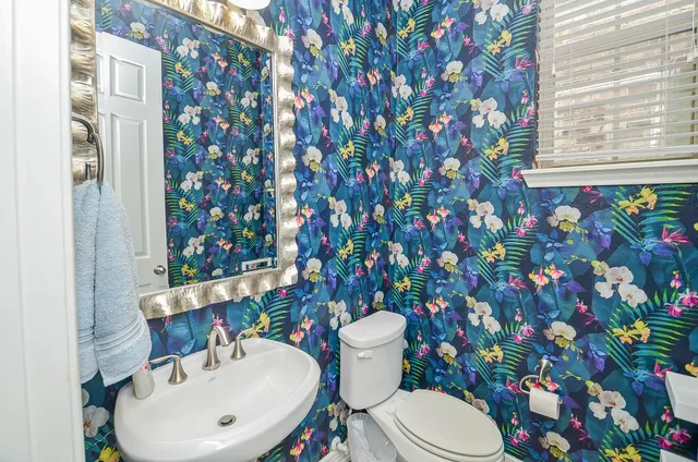 a bathroom with a sink mirror and toilet