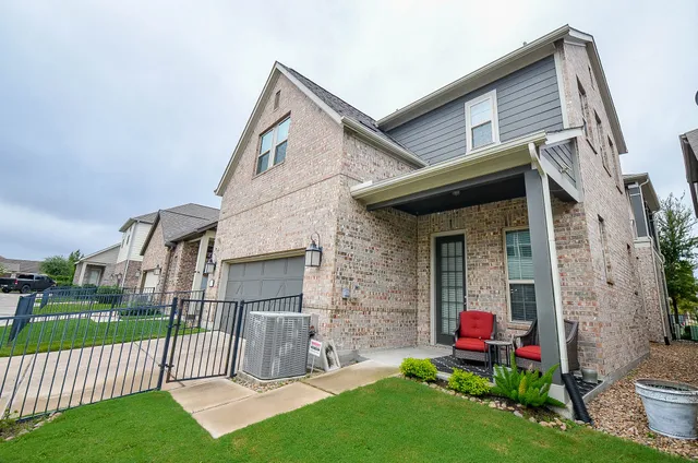 a view of a house with a yard and porch