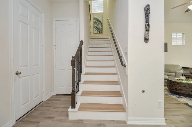 a view of entryway and hall with wooden floor
