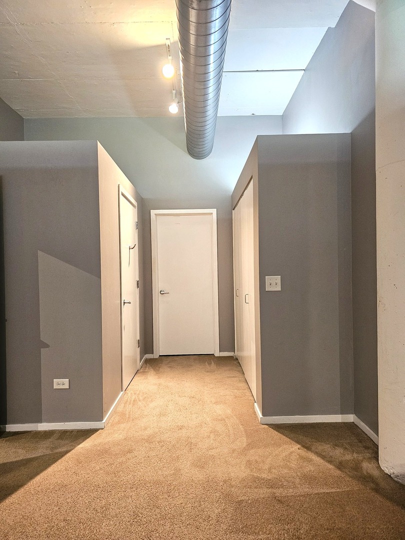 2323 West Pershing Road, Unit 230 Chicago, IL 60609 - Photo 22 of 39 a view of an empty room with wooden door