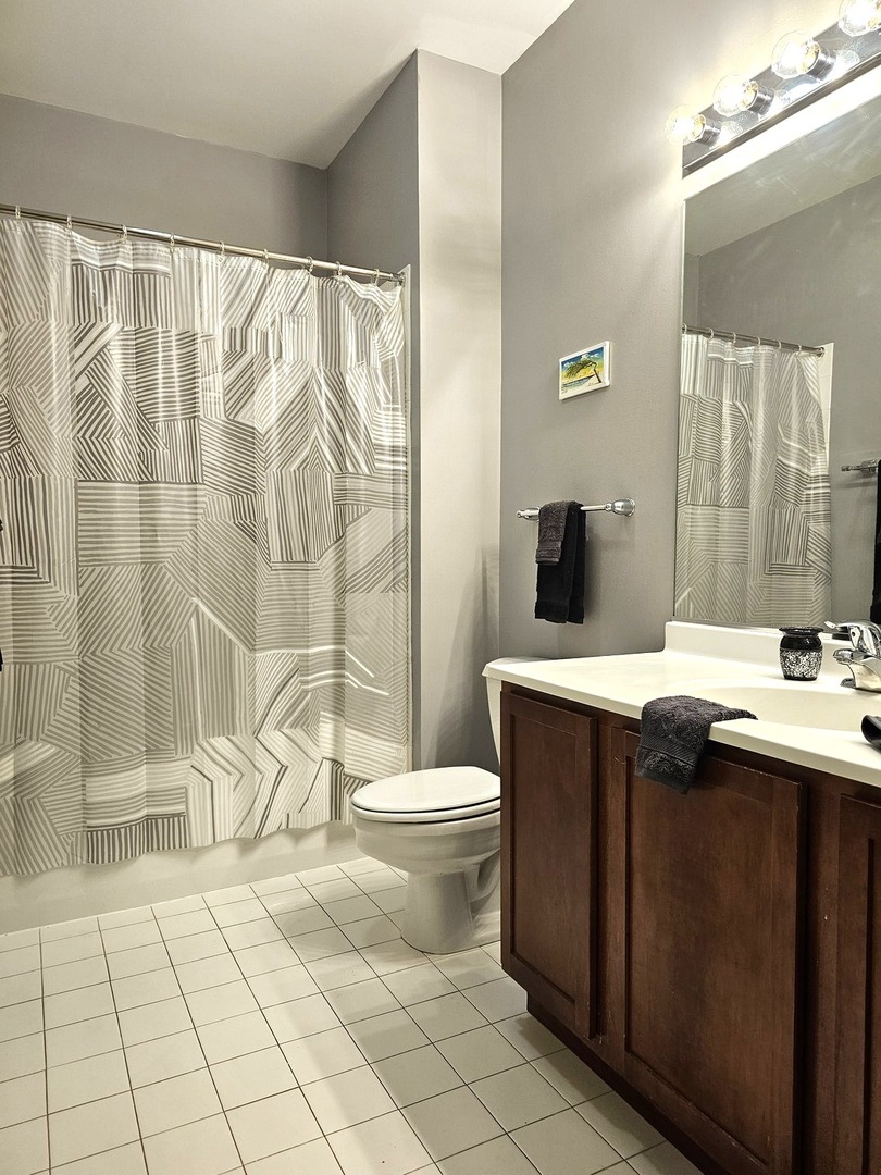 2323 West Pershing Road, Unit 230 Chicago, IL 60609 - Photo 27 of 39 a bathroom with a sink toilet and shower