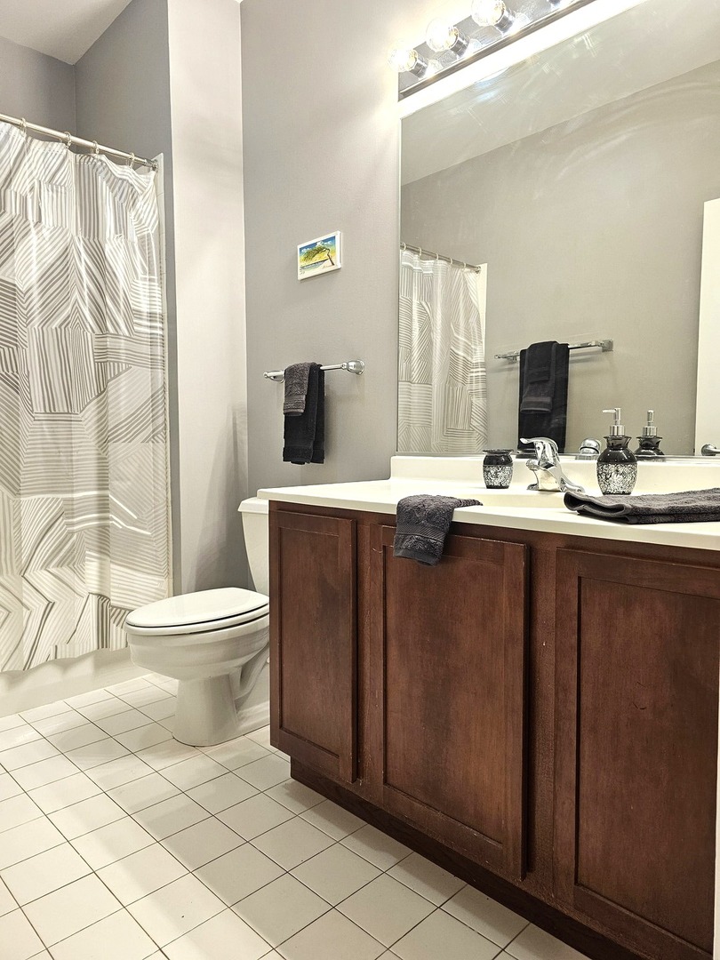 2323 West Pershing Road, Unit 230 Chicago, IL 60609 - Photo 28 of 39 a bathroom with a toilet sink and mirror