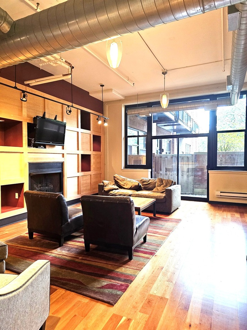 2323 West Pershing Road, Unit 230 Chicago, IL 60609 - Photo 33 of 39 a living room with furniture and a fireplace