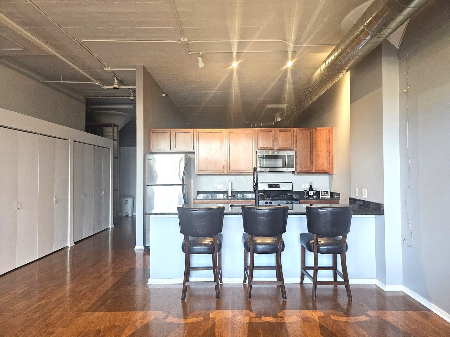 2323 West Pershing Road, Unit 230 Chicago, IL 60609 - Photo 5 of 39 a dining room with furniture a chandelier and wooden floor