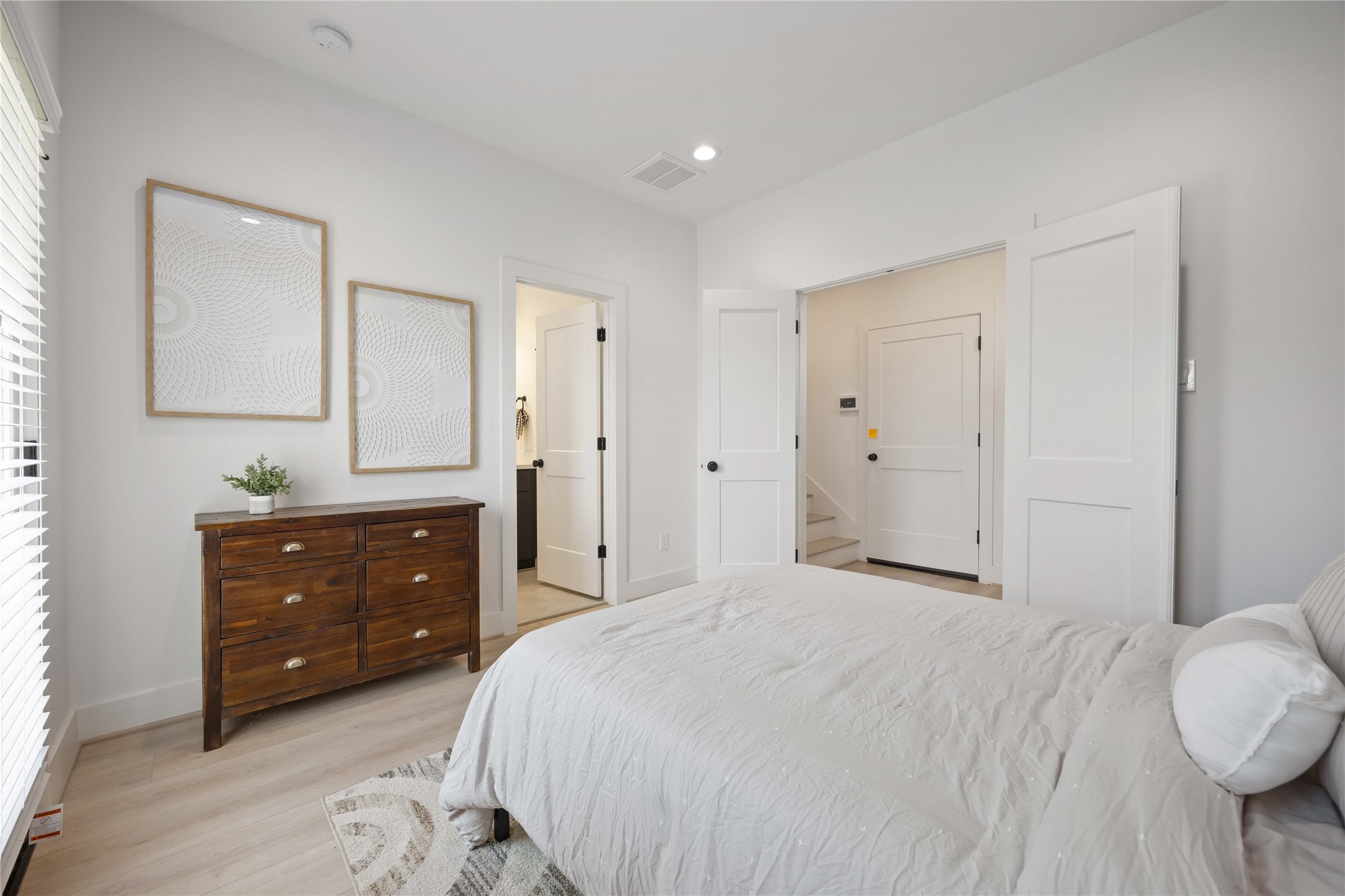 7807 Amelia Road, Unit B Houston, TX 77055 - Photo 13 of 30 a bedroom with a bed and a dresser