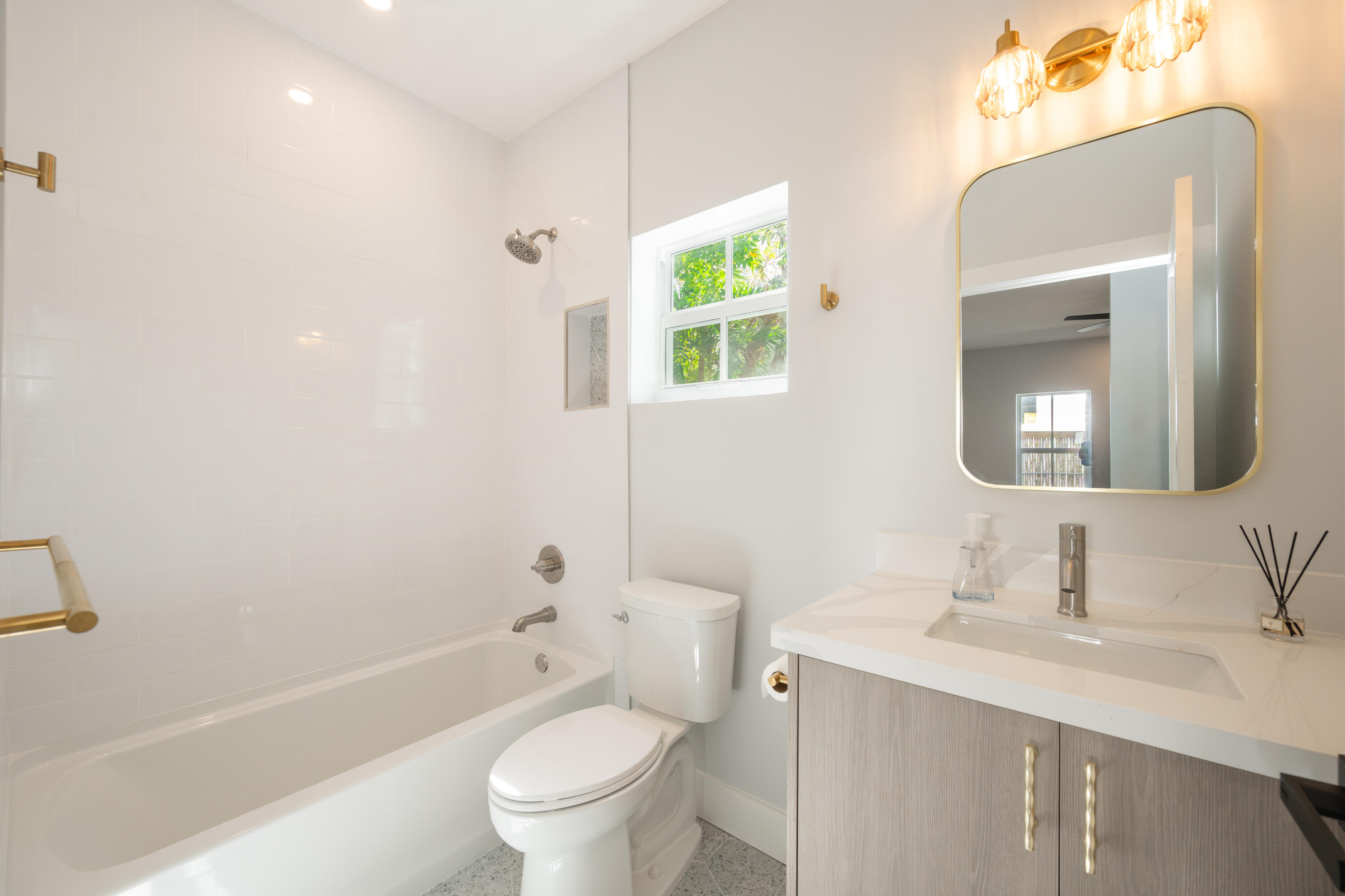 1315 William Street Key West, FL 33040 - Photo 24 of 26 a bathroom with a toilet a sink a tub and mirror