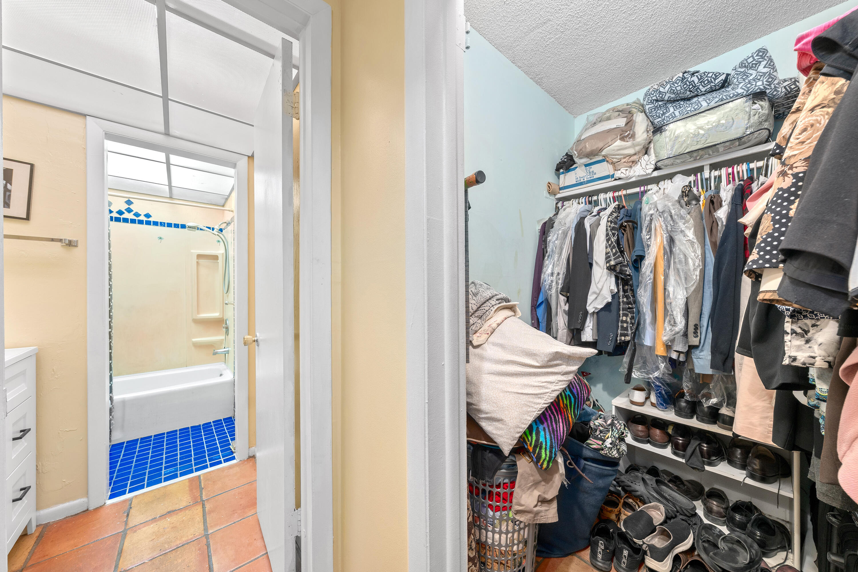 628 Northwest 13th Street, Unit 11 Boca Raton, FL 33486 - Photo 15 of 22 a view of walk in closet with clothes and shoes