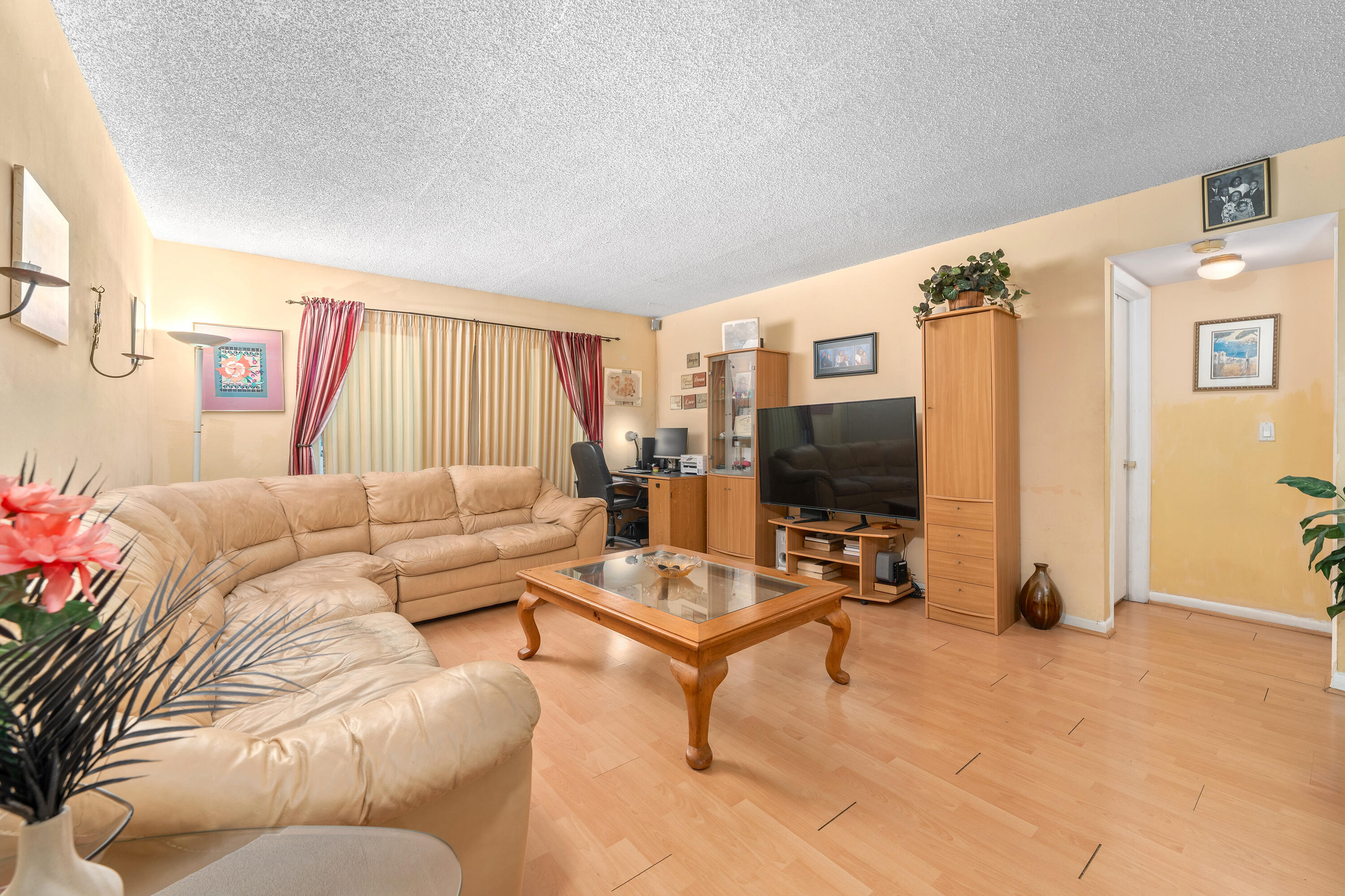 628 Northwest 13th Street, Unit 11 Boca Raton, FL 33486 - Photo 9 of 22 a living room with furniture and a flat screen tv