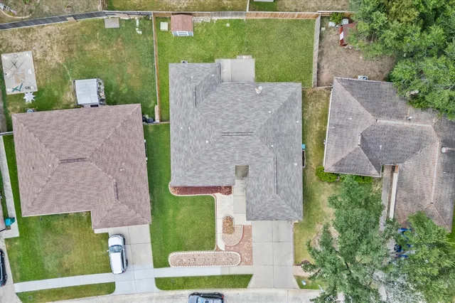 an aerial view of a house with garden space and street view