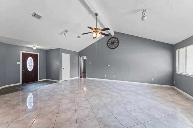 a view of a livingroom with furniture and chandelier fan